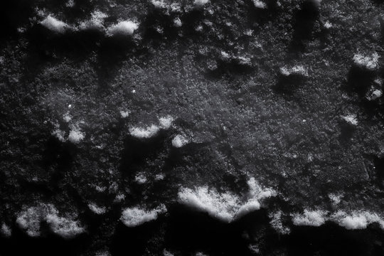 Snow surface under artificial lighting as an abstraction and background closeup.