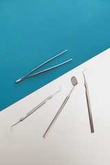 Dentist tools on a blue background top view