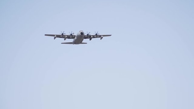 An airplane flying through the skies in slow motion.Lockheed Martin C-130J Super Hercules