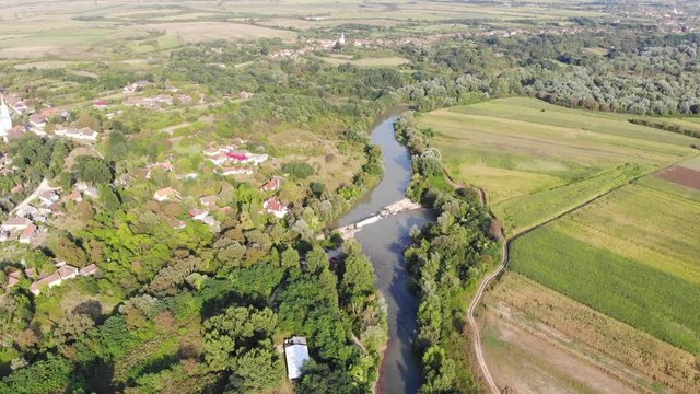 Drone Aerial Romania countryside river trees swamp green field above rivers