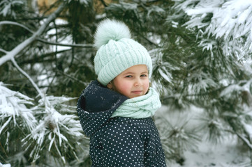 Portrait of a little girl on a walk on a winter day