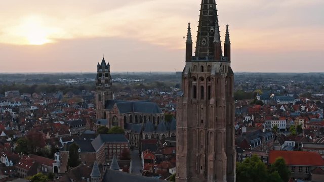 Belgium, Bruges: rising near Church of Our Lady and St. Salvator's Cathedral at sunset