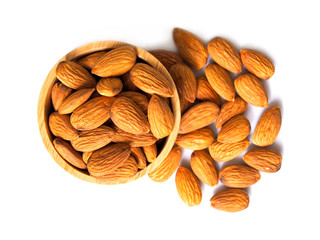 dried almonds in wooden bowl isolated on white background.