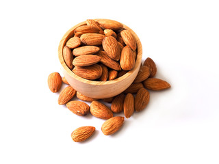 Top view of almond seeds in wooden bowl isolated on white background.