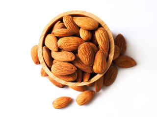 above of dried almonds in wooden bowl isolated on white background.