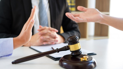 Couple husband and wife during divorce process listening to lawyer dissolves marriage contract, Dissolution of marriage concept.