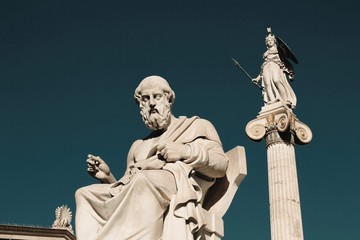 The statues of the ancient Greek philosopher Plato and Greek Goddess Athena outside of the Academy...