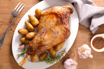 baked lamb leg with potato and sauce