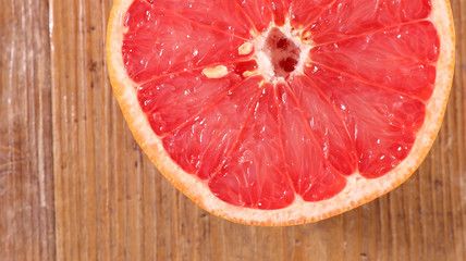 red grapefruit on wood background