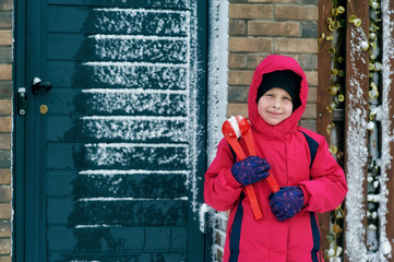 Portrait of a girl in a warm jumpsuit on a winter day . Children on a walk in the winter season