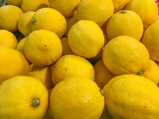 Fresh Lemons set as a background in market.Healthy eating.