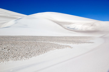 Fototapeta na wymiar White dune at the lava field of the volcano Caraci Pampa at the Puna de Atacama, Argentina