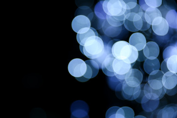 background with blurred blue circles of lights. defocused lights of festive garland