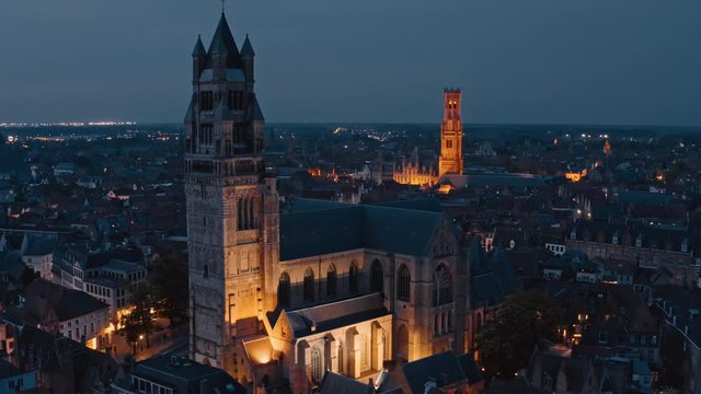 Belgium, Bruges: night typical view of St. Salvator's Cathedral and tower of Belfort Van Brugge