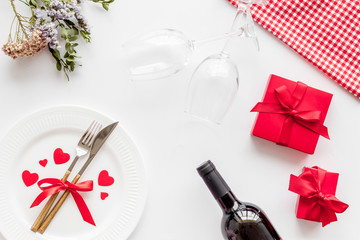 Valentines day table. Plate and wine on white background top-down