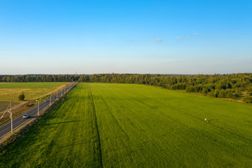Fototapeta na wymiar Aerial view of the road through the agricultural field
