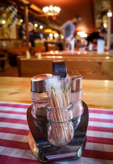 Seasonings and toothpicks on a table in a restaurant