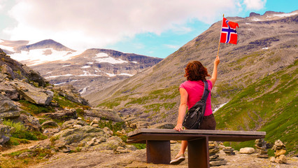 Naklejka premium Tourist with norwegian flag on Trollstigen area