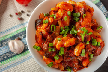 Braised white beans with mushrooms and tomatoes in spicy sauce