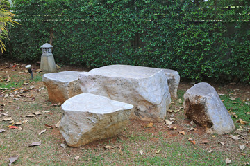 Marble stone bench set in the garden. Stone furniture.