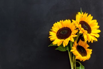 Foto op Aluminium Bouquet of sunflowers on black background top-down copy space © 9dreamstudio