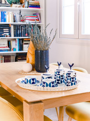 Retro ceramic teapot and cups on a wooden table in a cozy stylish bright living room with natural style