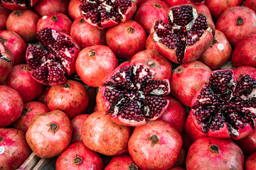 Red pomegranate fruit at street market. Group of pomegranates