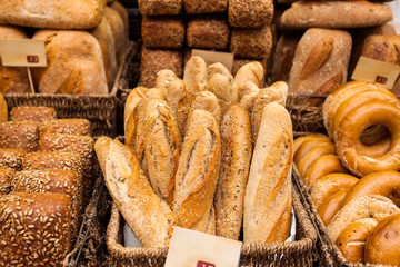 Many mixed breads and rolls shot from above.