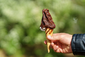 Man holding ice cream cone. Chocolate ice cream