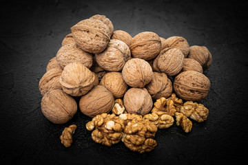 Walnuts on black background. Group walnuts on Healthy organic food concept.