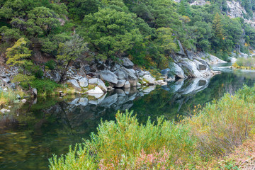Fototapeta na wymiar Boulders reflected in the North Fork of the Feather River near Cresta, California, USA