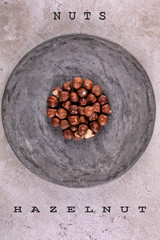 nuts on a gray round stand, with the name