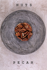 nuts on a gray round stand, with the name