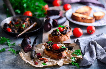Black pudding with onion crostini.selective focus