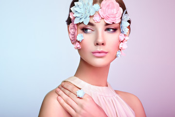 Face of Beautiful Woman Decorated with Flowers. Perfect Makeup. Beauty Fashion Model Woman Face perfect Skin. Paper Flowers