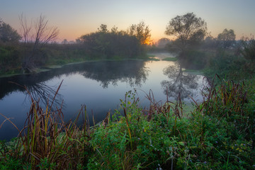 Fototapeta na wymiar Misty sunrise on the river