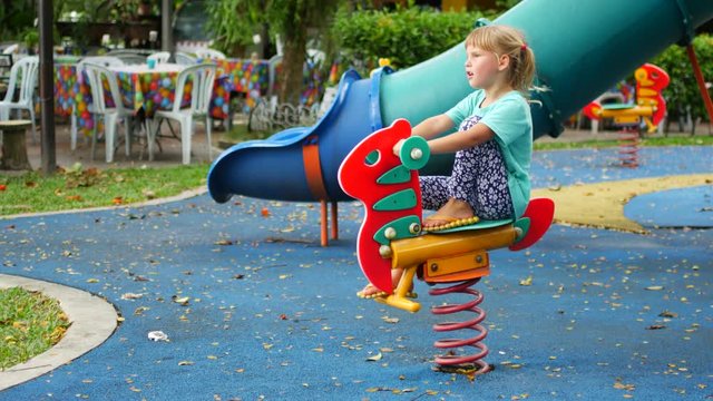 Child girl on the playground, day off