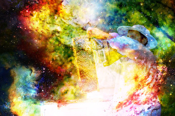 Obraz na płótnie Canvas Beekeeper manipulating with honeycomb full of golden honey on abstract structured space background.