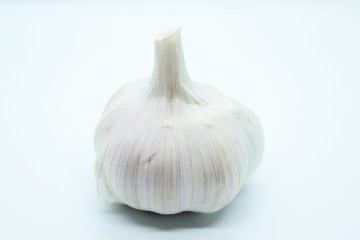 Garlic head located on a white background