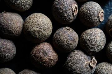 Background with whole black peppercorns