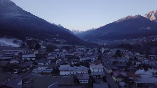Flying over the peaceful valley of Mieders, Austria during a cold winter sunrise - Aerial shot