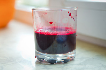 Fresh juice just made from beetroot a glass shot from bird-eye-perspective isolated on white background . Glass of beet juice isolated on white .