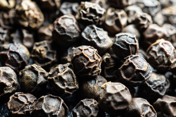 Background with whole black peppercorns