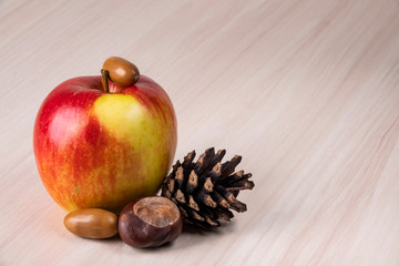 apples and nuts on wooden background
