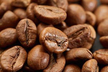 Roasted coffee beans close up. Espresso dark, aroma, black caffeine drink