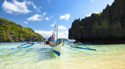 Stunning view of a Bangka floating on a turquoise, crystal clear sea. A Bangka is a double...