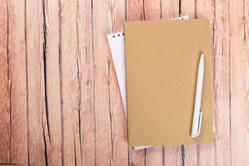blank notebook with pen on a wooden table, business concept concept of a new workplace