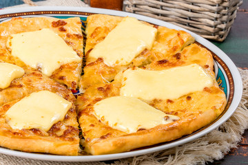Caucasian dish khachapuri with egg served on a white plate