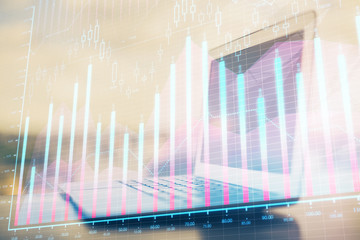 Stock market graph and table with computer background. Double exposure. Concept of financial analysis.