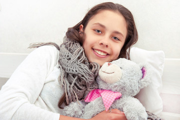 Teen girl with a toy teddy bear